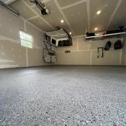 Gray flake epoxy garage floor coating with storage wall in Martinsburg, WV